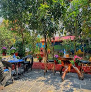 a painting of a patio with tables and chairs at Hotel The Mint Garden in Pokhara