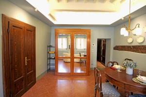 a living room with a table and a dining room at La Casa sulla Piazza in Cortona