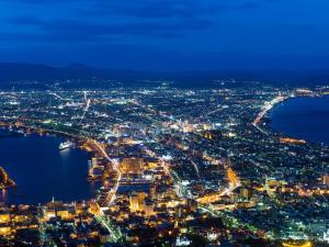 an aerial view of a city at night at HOTEL MYSTAYS Hakodate Station in Hakodate +115 photos