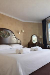 a bedroom with two beds with white sheets and two windows at Apartamenty Port 111 in Kołobrzeg