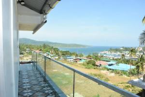 a balcony of a house with a view of the ocean at Sea Shore In in Port Blair