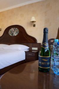 a bottle of port inhibitor sitting on a table in a bedroom at Apartamenty Port 111 in Kołobrzeg +8 photos