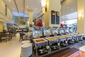 a buffet line of food in a restaurant at Cape Racha Hotel in Si Racha