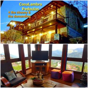 a living room with a large window and a tv at CasaLambra Pedoulas Exclusive Accomodation Troodos Mountains in Pedoulas