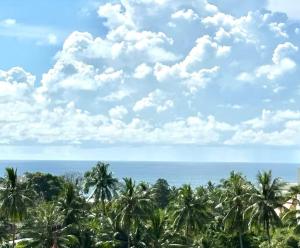 a view of the ocean and palm trees at Apartment Karon SeaView 72 sq in Karon Beach