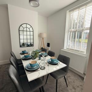 a dining room with a white table and chairs at 171 Stroud Road in Gloucestershire