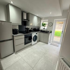 a kitchen with a stove and a dishwasher at 171 Stroud Road in Gloucestershire