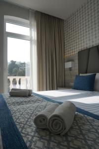 a hotel room with a bed with towels on it at Hotel Fiesa in Piran