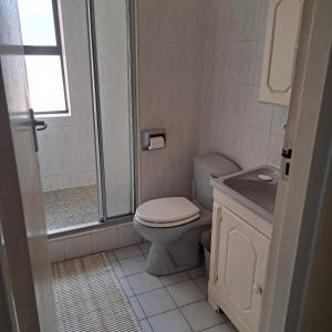 a bathroom with a toilet and a sink at Hibberdene Beachfront Self-Catering 9 Catalina Bay in Hibberdene +16 photos