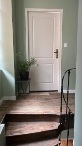 a white door with a potted plant in a room at Le Dorat Bright & Quiet in Le Dorat