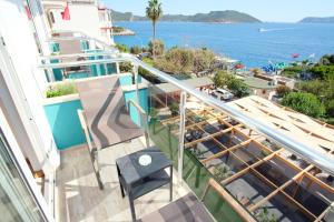 a balcony with stairs and a view of the ocean at Nur Hotel in Kaş