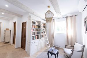 a room with a book shelf with books at La Bastide des Lavandins in Le Thor