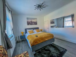 a bedroom with a bed and a ceiling fan at Eugino Properties in Grays Thurrock