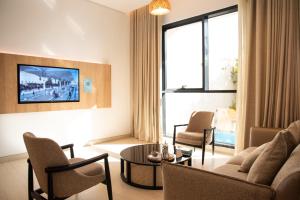 a living room with a couch and chairs and a table at Hafawah Resort in Medina