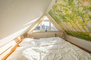 a bedroom with a large bed in a attic at Küstenglück in Neustadt in Holstein