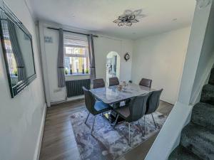 a dining room with a table and chairs at Eugino Properties in Grays Thurrock