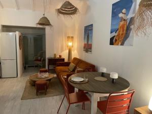 a living room with a couch and a table at L'escapade in Saint-Tropez