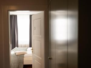 a room with a bed and a door with a window at B&B Zoo Caffè & Ristorante in Zurich +29 photos