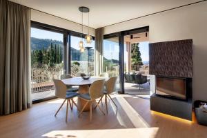 a dining room with a table and chairs and a fireplace at Villa Olivida in Garda