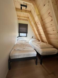 two beds in a room with a attic at Parc Sonnleiten - A Chalet in Gnesau
