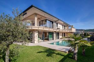 an image of a house with a swimming pool at Villa Olivida in Garda