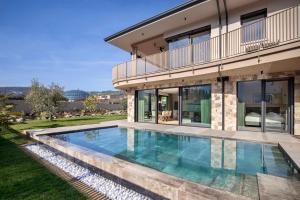 a swimming pool in the backyard of a house at Villa Olivida in Garda