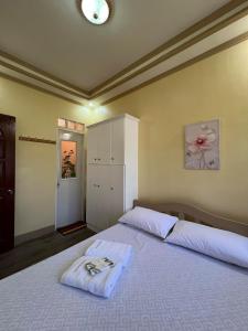 a bedroom with a large white bed in a room at Nielo's Apartment Door 5 in Dapitan