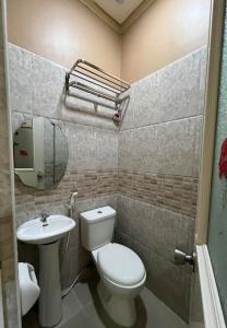 a bathroom with a toilet and a sink at Nielo's Apartment Door 5 in Dapitan