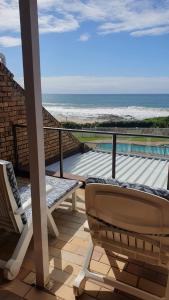 a balcony with a chair and a view of the ocean at Hibberdene Beachfront Self-Catering 9 Catalina Bay in Hibberdene