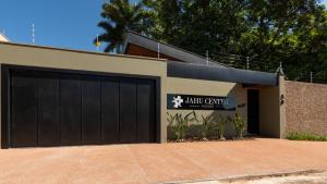 a garage with a black garage door on a house at Jahu Center House in Jaú +72 photos