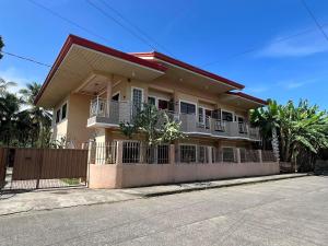 a house with a fence in front of it at Nielo's Apartment Door 5 in Dapitan