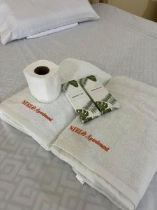 a pair of towels and a roll of toilet paper on a bed at Nielo's Apartment Door 5 in Dapitan +3 photos