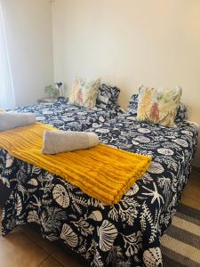 a bedroom with two beds with a blanket on it at KleinHenties in Hentiesbaai