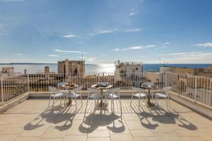 a patio with tables and chairs on a balcony at Dimora Suite Platino in Gallipoli