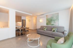 a living room with a couch and a table at Ereza Suites in Arrecife