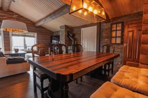 a dining room with a wooden table and chairs at Meraftahornvegen 36 in Stranda