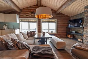 a living room with a couch and a table at Meraftahornvegen 36 in Stranda