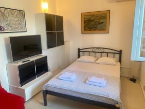 a small bedroom with a bed with two towels on it at Apartment Sanja in Primošten