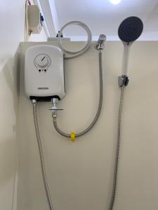 a shower in a hospital room with a stethoscope at Cardo Rooms 2 minutes walk from the beach in General Luna