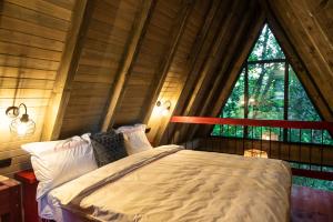 a bed in a room with a large window at Hai La Munte Bran in Bran