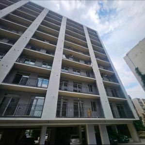 a tall apartment building with balconies on the side of it at Tbilisi- Georgia in Tbilisi City