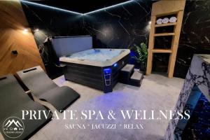 a bath tub in a room with a table and chairs at Domek A - domki w górach z prywatnym SPA - 4 seasons lodges Ustroń in Ustroń