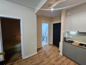 a kitchen with white cabinets and wooden floors in a room at Tbilisi- Georgia in Tbilisi City +9 photos