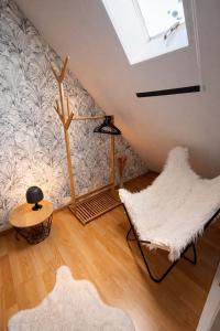 a room with two chairs and a skylight at Le petit nid de St-Germain in Saint-Germain