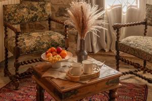 a room with a table with a bowl of fruit on it at La Maison Bakéa in Cordes-sur-Ciel