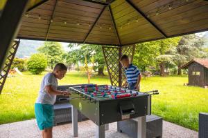 two young men playing a game on a table at Residence CATULLO in Bezzecca