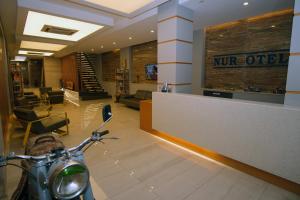 a motorcycle parked in a lobby with a mr officer counter at Nur Hotel in Kaş