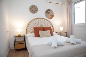 a bedroom with a large white bed with two tables at Casa Mari Pepa beach & pool in Benajarafe +18 photos