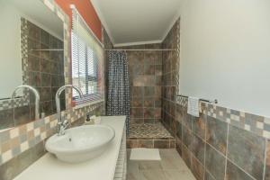 a bathroom with a sink and a shower at Accommodation on 3329 - Unit 3 in Gqeberha +23 photos