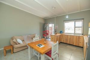 a living room with a table and a couch at Accommodation on 3329 - Unit 3 in Gqeberha
